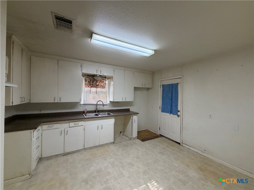 1902 Navidad Street Victoria, TX 77901 - Photo 12 of 23 a large kitchen with a sink and cabinets