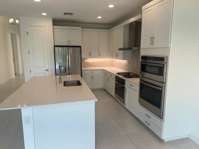 a kitchen with a sink a stove and refrigerator
