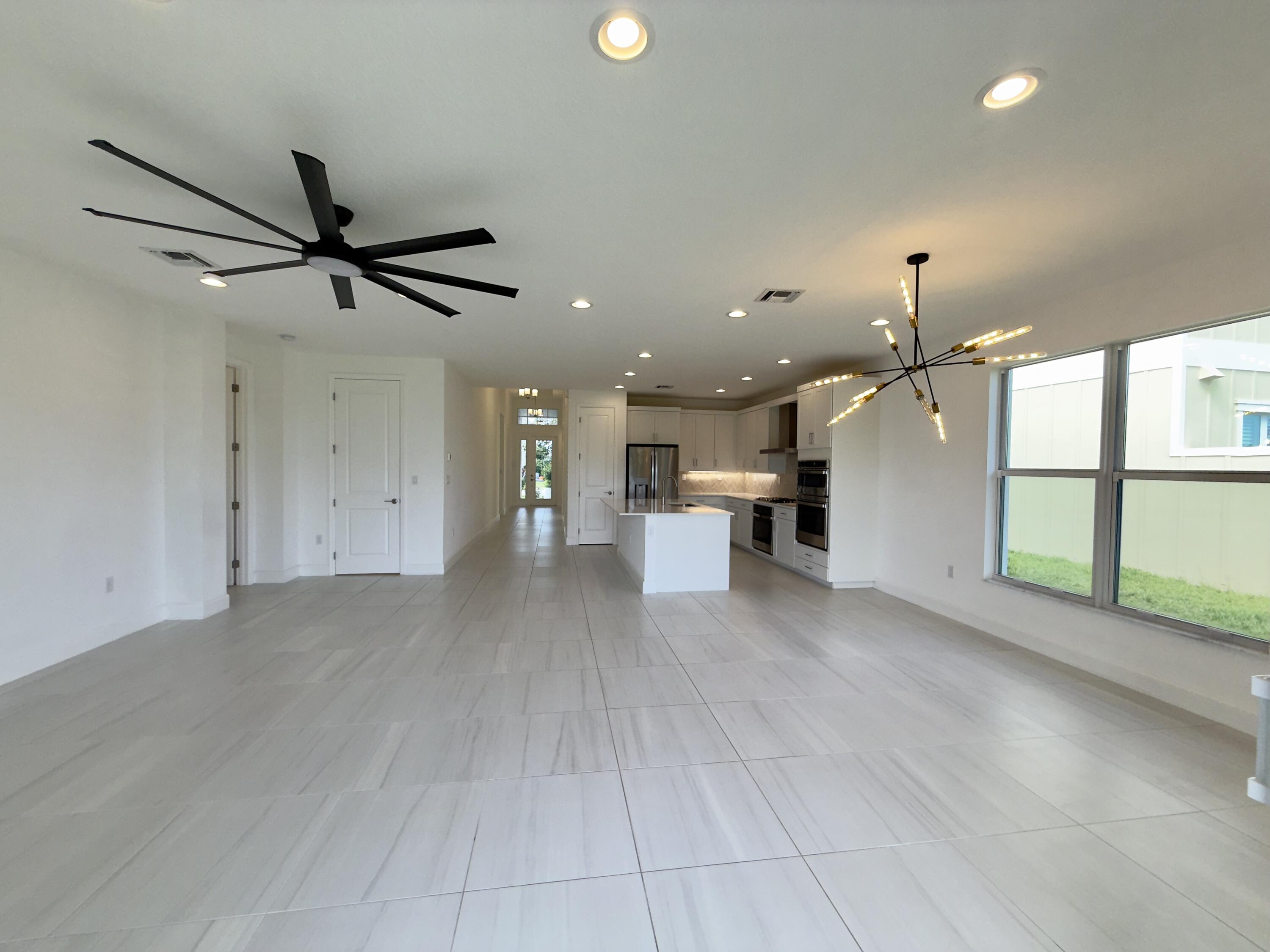 1346 Harvester Crossing Loxahatchee, FL 33470 - Photo 18 of 43 a view of a kitchen with a sink and a window