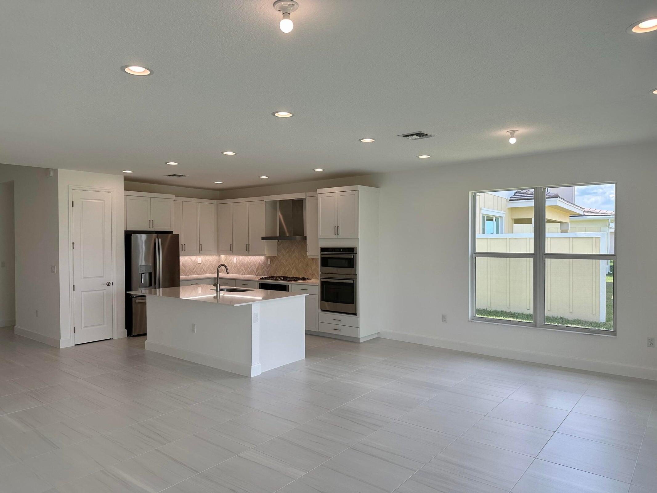 1346 Harvester Crossing Loxahatchee, FL 33470 - Photo 19 of 43 a view of a kitchen with a sink cabinets and window