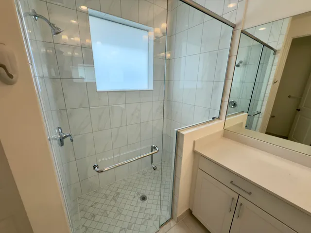 a bathroom with a sink and shower