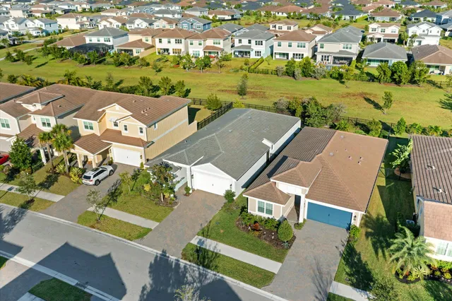 an aerial view of residential houses with outdoor space and swimming pool