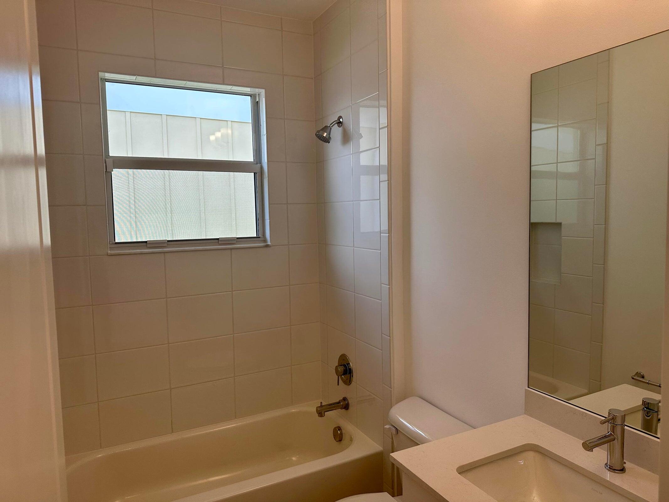 1346 Harvester Crossing Loxahatchee, FL 33470 - Photo 32 of 43 a bathroom with a sink and a bathtub