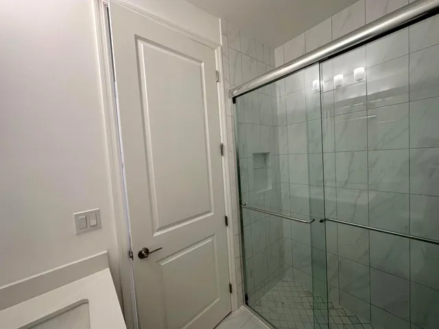 a bathroom with a glass shower door