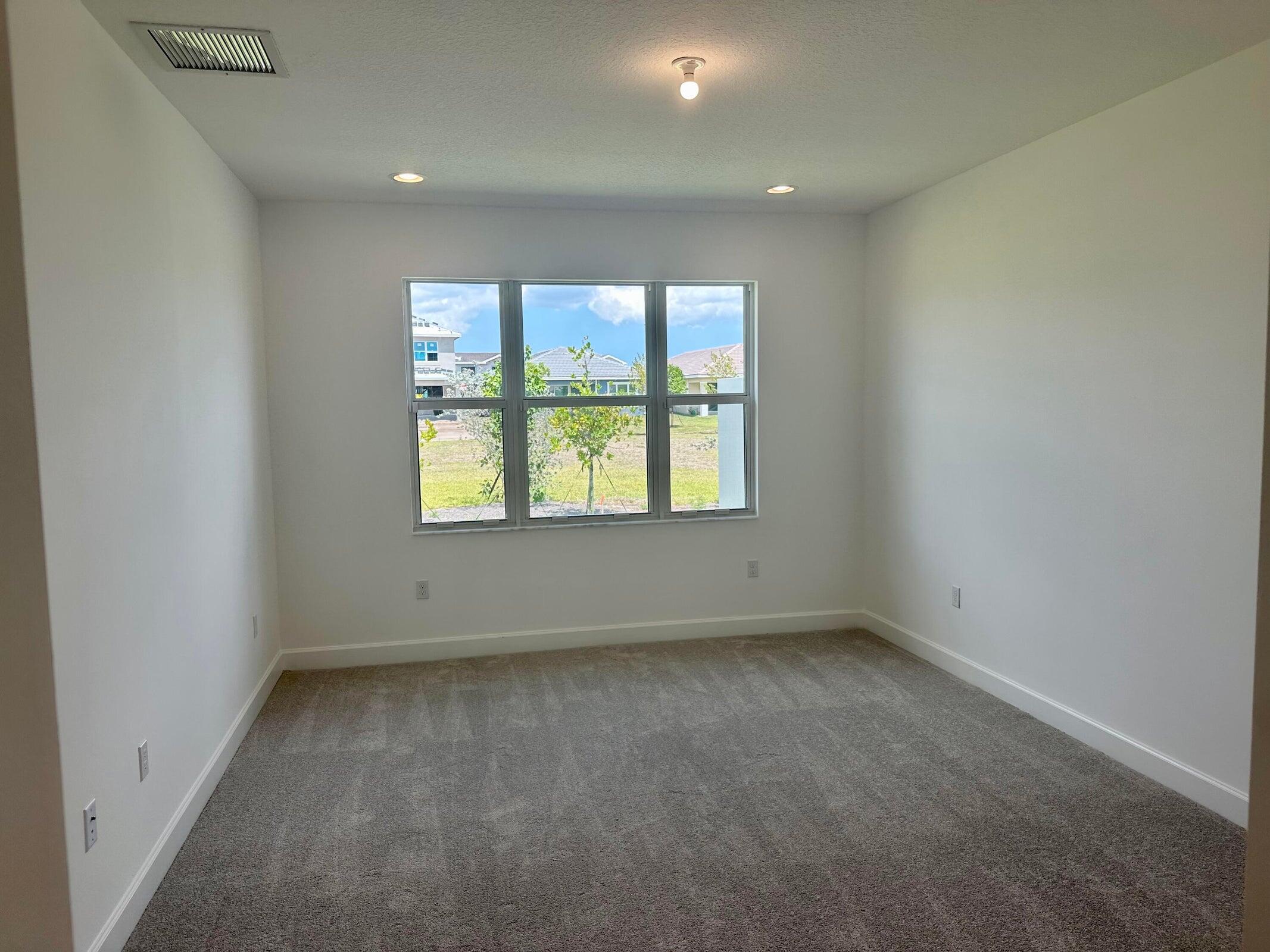1346 Harvester Crossing Loxahatchee, FL 33470 - Photo 35 of 43 an empty room with a window