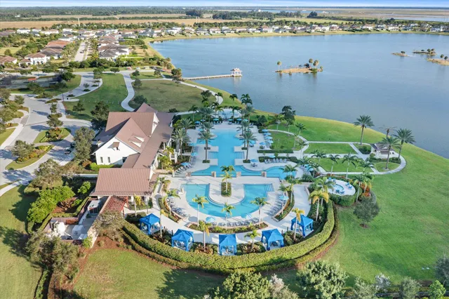 an aerial view of a house with swimming pool and ocean view