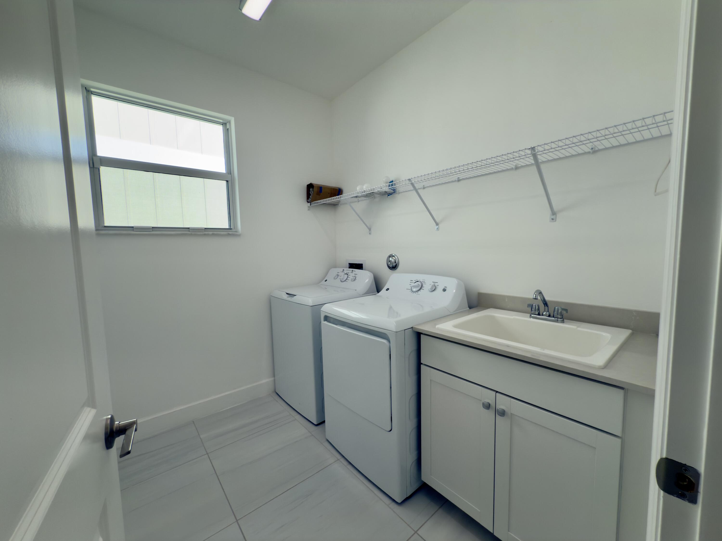 1346 Harvester Crossing Loxahatchee, FL 33470 - Photo 37 of 43 a utility room with dryer and washer