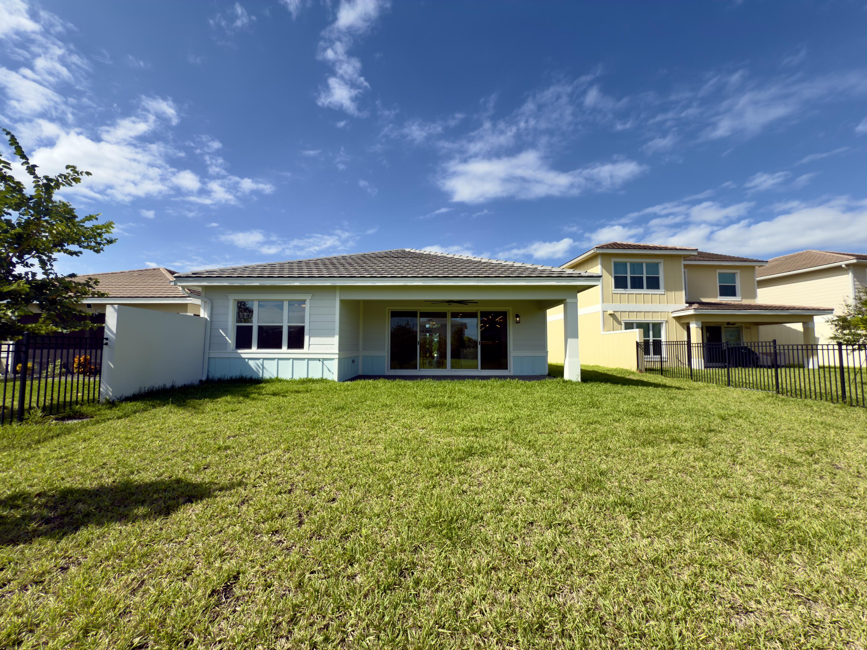 1346 Harvester Crossing Loxahatchee, FL 33470 - Photo 4 of 43 a view of a house with backyard and garden