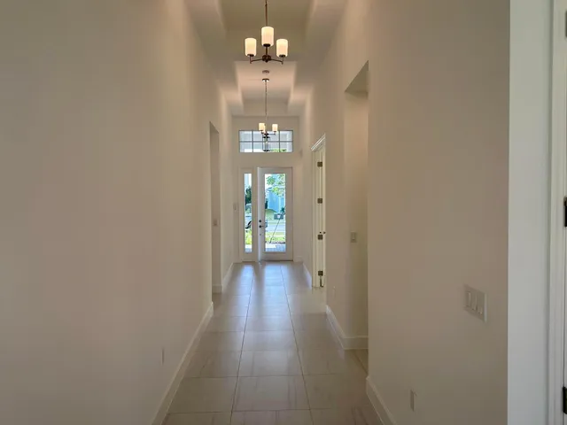 a very nice looking hallway with a chandelier