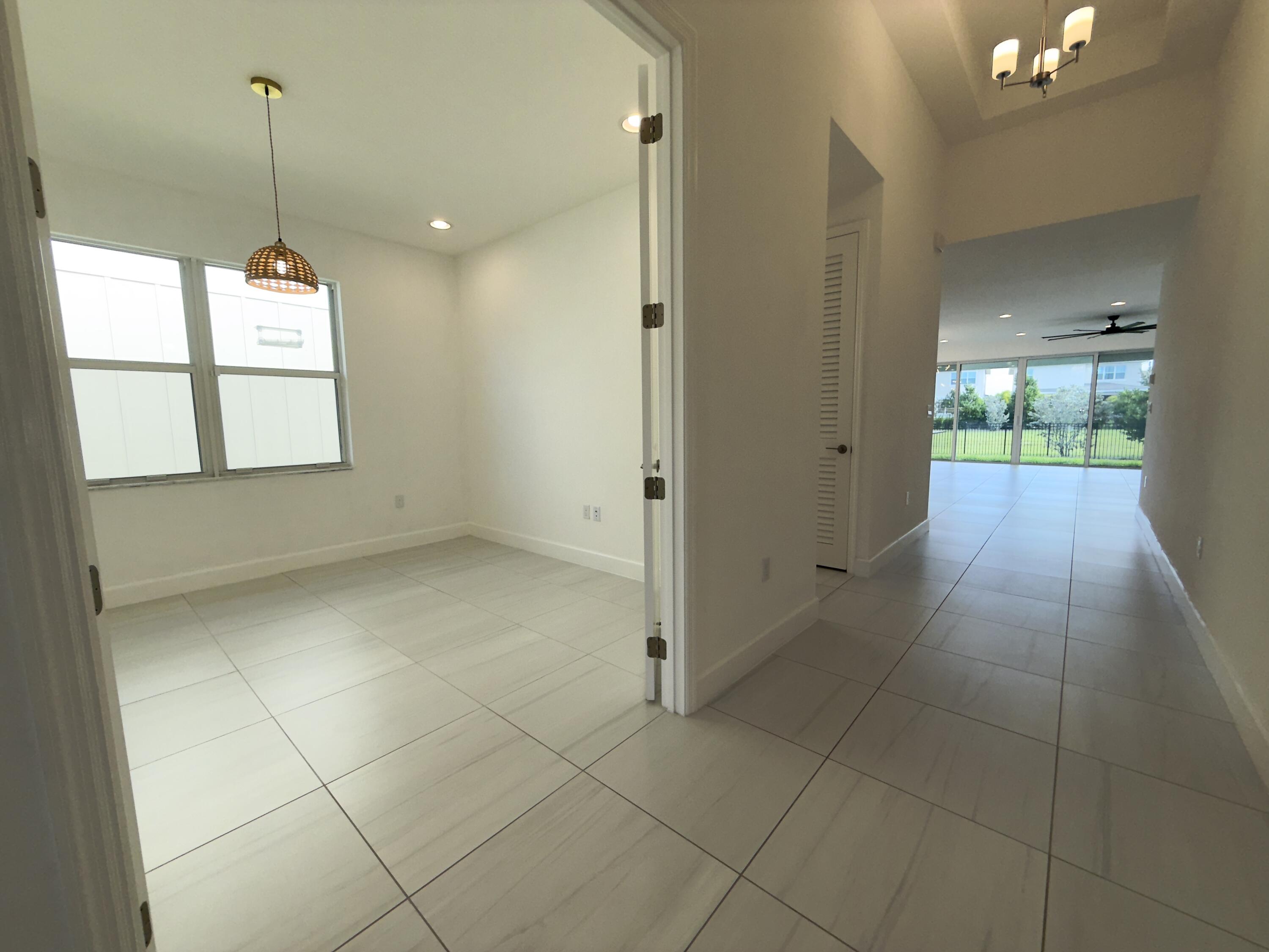 1346 Harvester Crossing Loxahatchee, FL 33470 - Photo 9 of 43 a view of an empty room and window