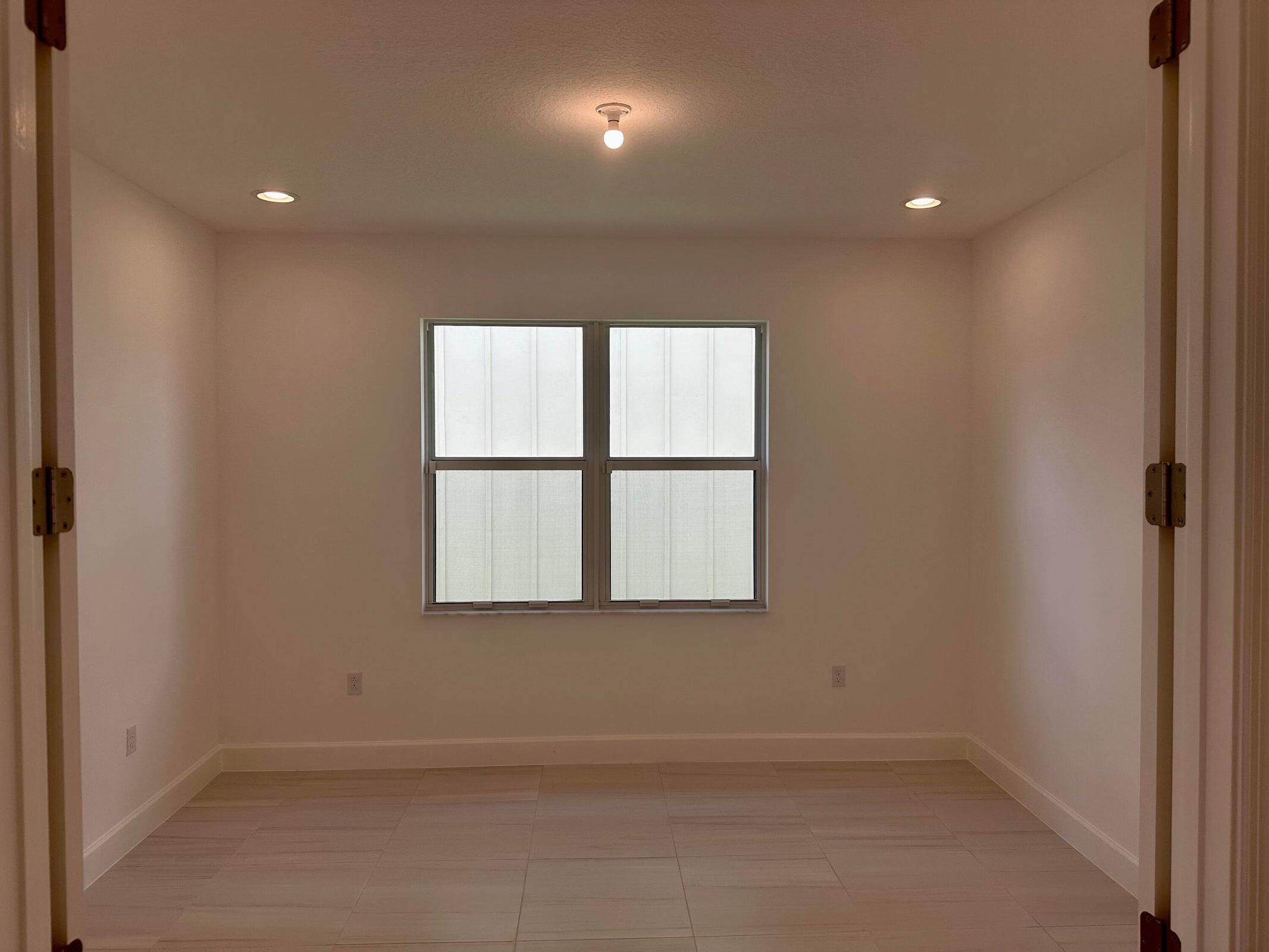 1346 Harvester Crossing Loxahatchee, FL 33470 - Photo 10 of 43 an empty room with a window