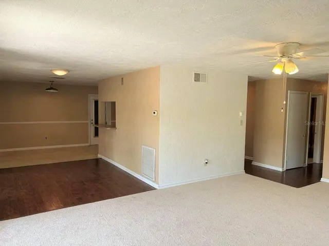 a view of a room with wooden floor