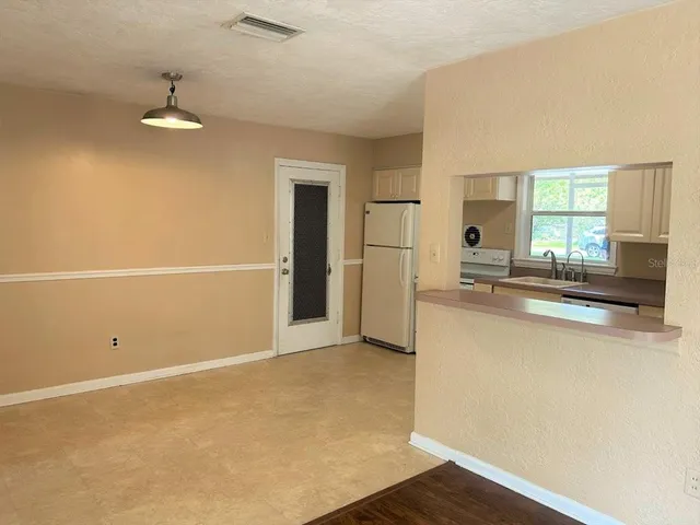 a view of a kitchen with a sink dishwasher and a refrigerator