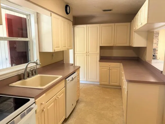 a kitchen with a sink and a refrigerator