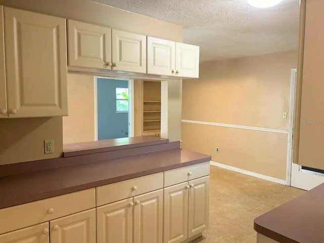 a kitchen with cabinets and a window