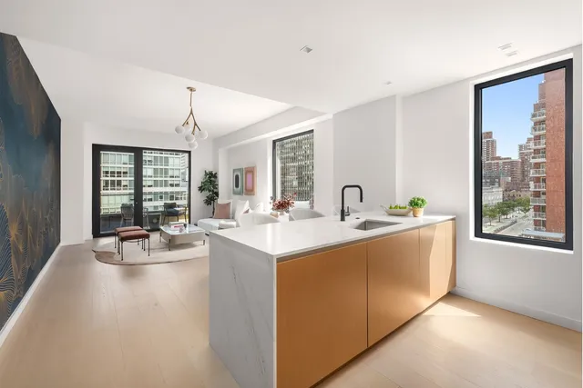 a view of living room with kitchen island furniture and front door