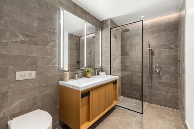 a bathroom with a sink toilet and shower