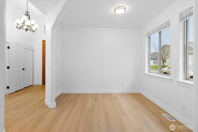 a view of a room with wooden floor and window