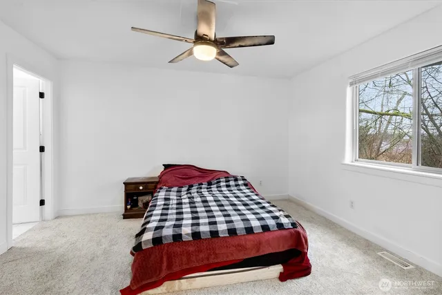 a bedroom with a bed and a window