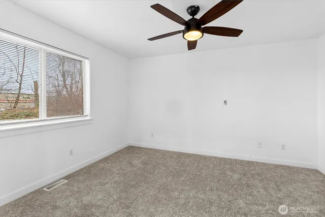 a bedroom with bed and a ceiling fan