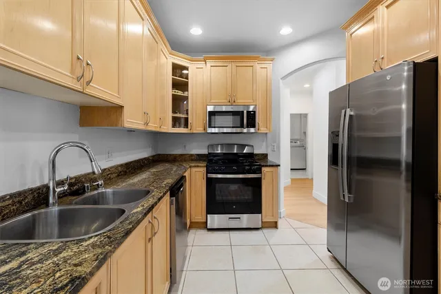 a kitchen with a sink cabinets and stainless steel appliances