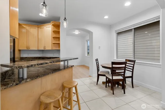 a kitchen with a table chairs and a refrigerator