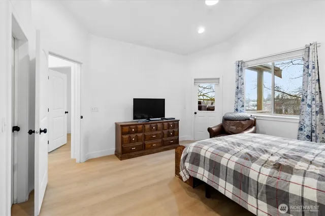 a bedroom with a bed and a flat screen tv