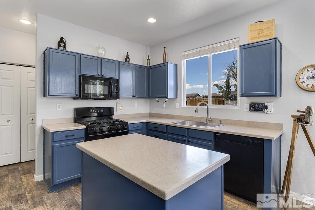 2267 Big Trail Circle Reno, NV 89521 - Photo 18 of 37 a kitchen with stainless steel appliances a sink a stove a microwave a sink a refrigerator and cabinets