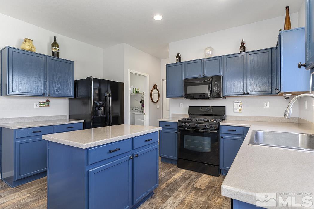 2267 Big Trail Circle Reno, NV 89521 - Photo 19 of 37 a kitchen with wooden cabinets and stainless steel appliances