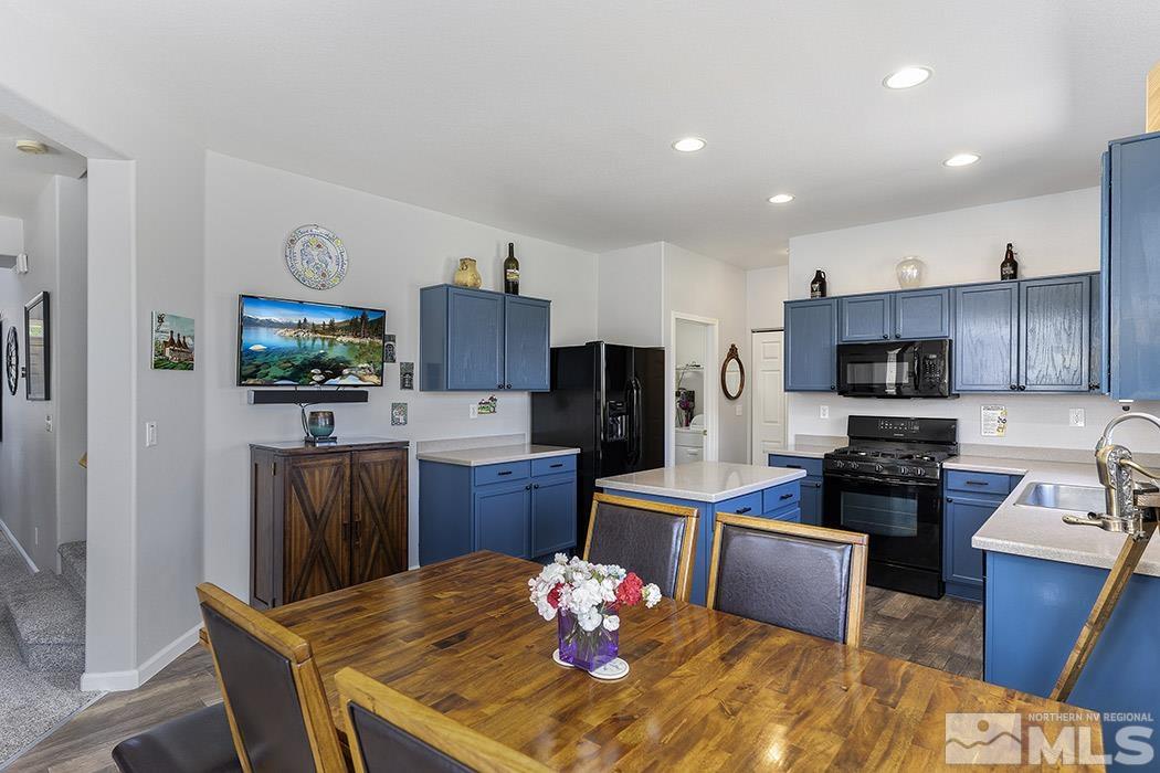 2267 Big Trail Circle Reno, NV 89521 - Photo 21 of 37 a kitchen with granite countertop stainless steel appliances microwave stove refrigerator and cabinets