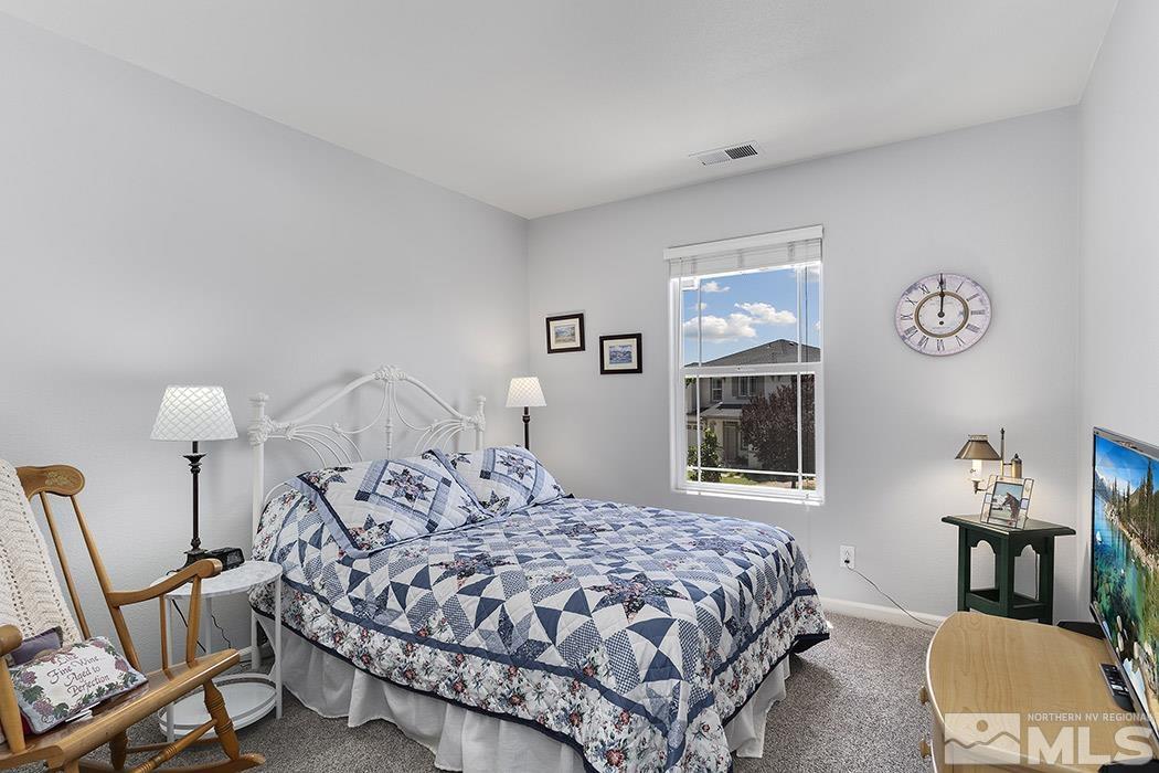 2267 Big Trail Circle Reno, NV 89521 - Photo 27 of 37 a bedroom with a bed a chair and a window
