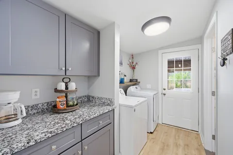 a kitchen with a sink cabinets and wooden floor