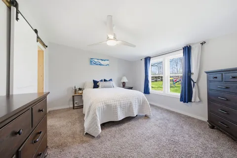 a spacious bedroom with a bed and a window