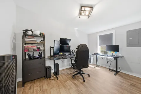 a view of a workspace with furniture and a window