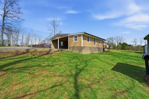 a front view of a house with yard and green space