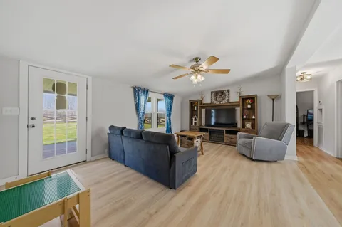 a living room with furniture and wooden floor