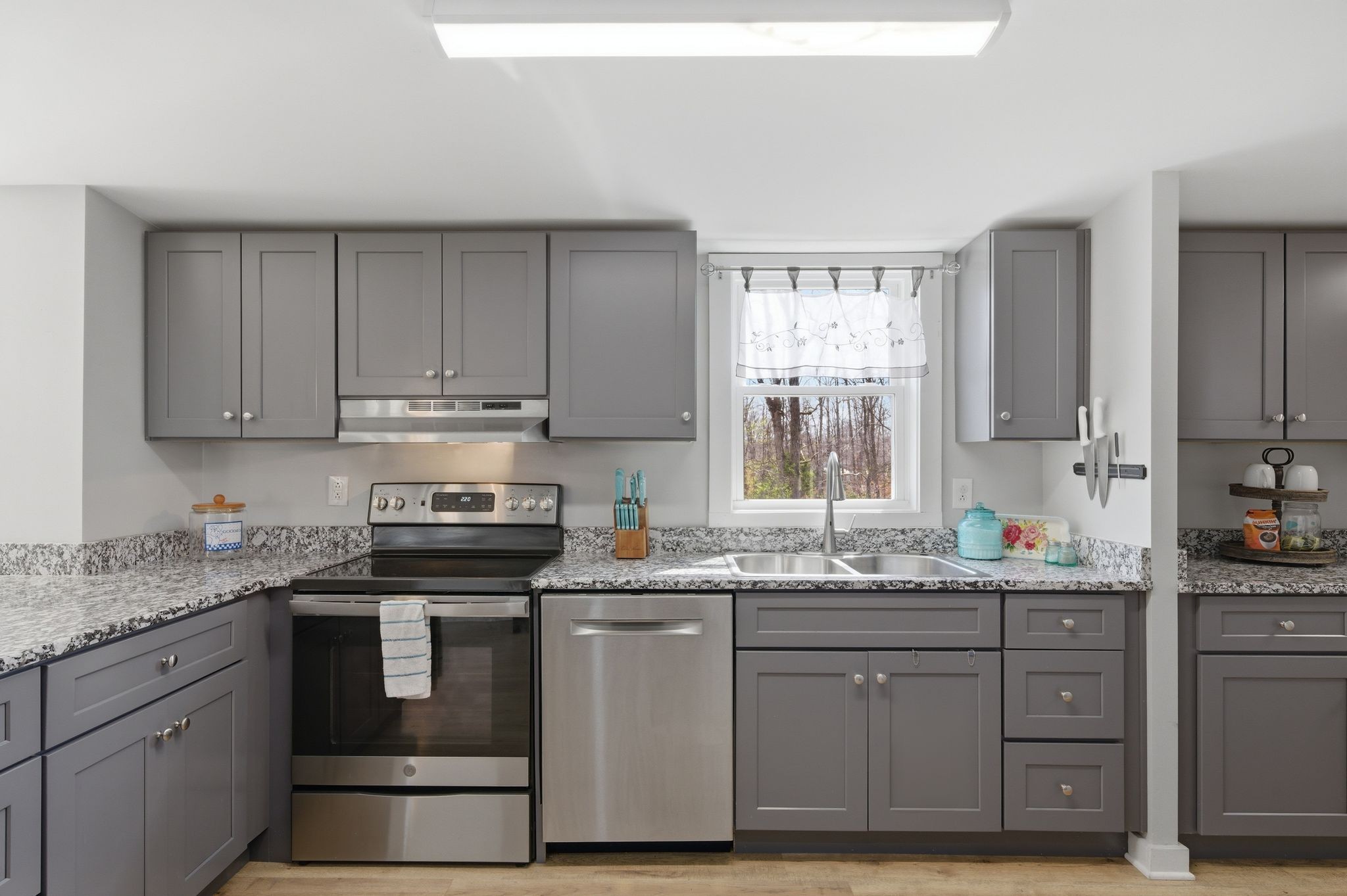 1225 Eno Road Dickson, TN 37055 - Photo 9 of 25 a kitchen with stainless steel appliances granite countertop a sink stove and cabinets