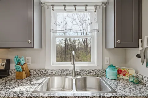 a kitchen with a sink and a window