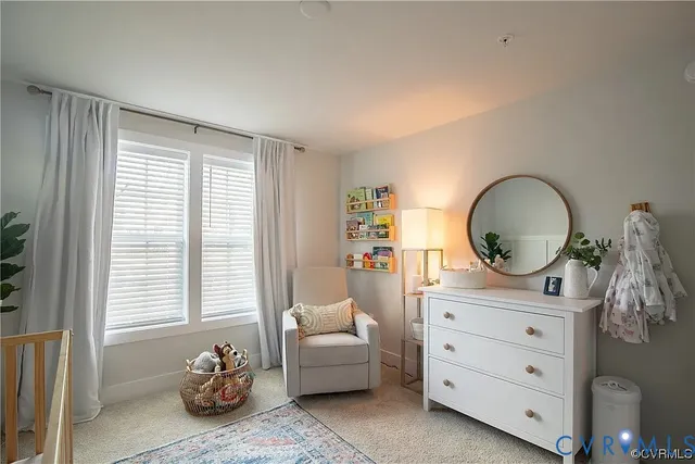a living room with furniture and a mirror