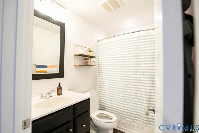 a bathroom with a toilet a sink and a mirror