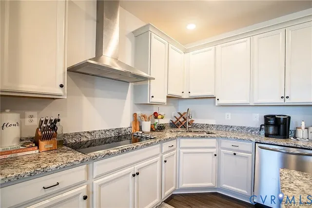 a kitchen with granite countertop white cabinets and white appliances