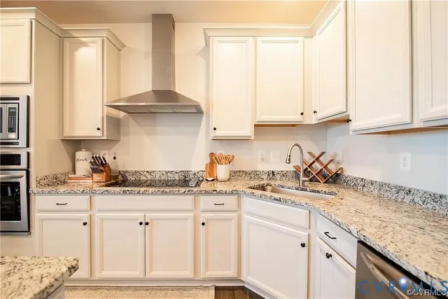 a kitchen with granite countertop white cabinets and a window