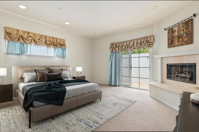 a spacious bedroom with a large bed and a fireplace