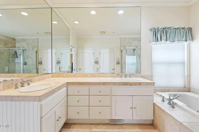a bathroom with a granite countertop sink mirror and double