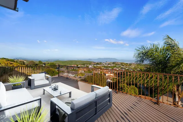 a view of a balcony with furniture