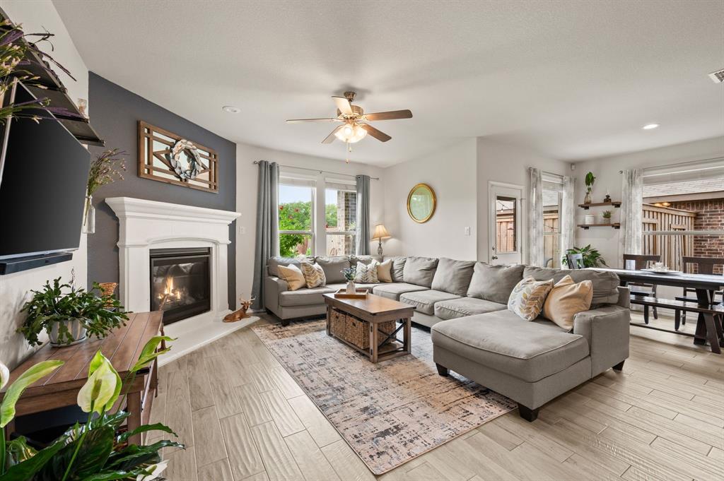 15817 White Mill Road Fort Worth, TX 76177 - Photo 8 of 27 a living room with furniture a fireplace and a flat screen tv