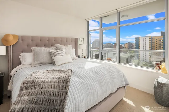 a bedroom with a large bed and a large window