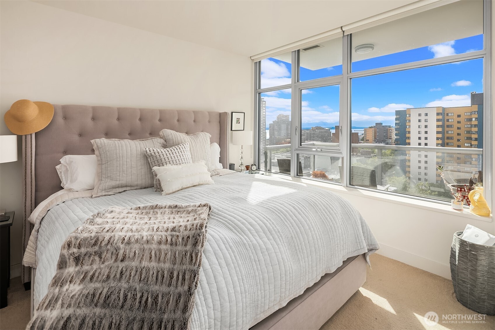 583 Battery Street, Unit 1405N Seattle, WA 98121 - Photo 11 of 37 a bedroom with a large bed and a large window