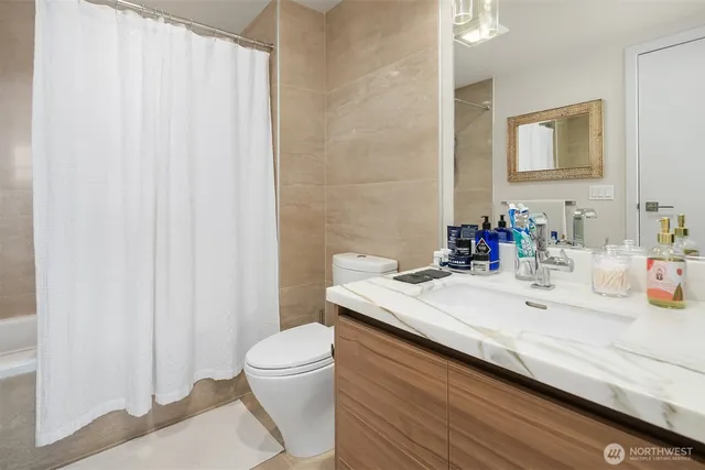 a bathroom with a sink a toilet and a mirror