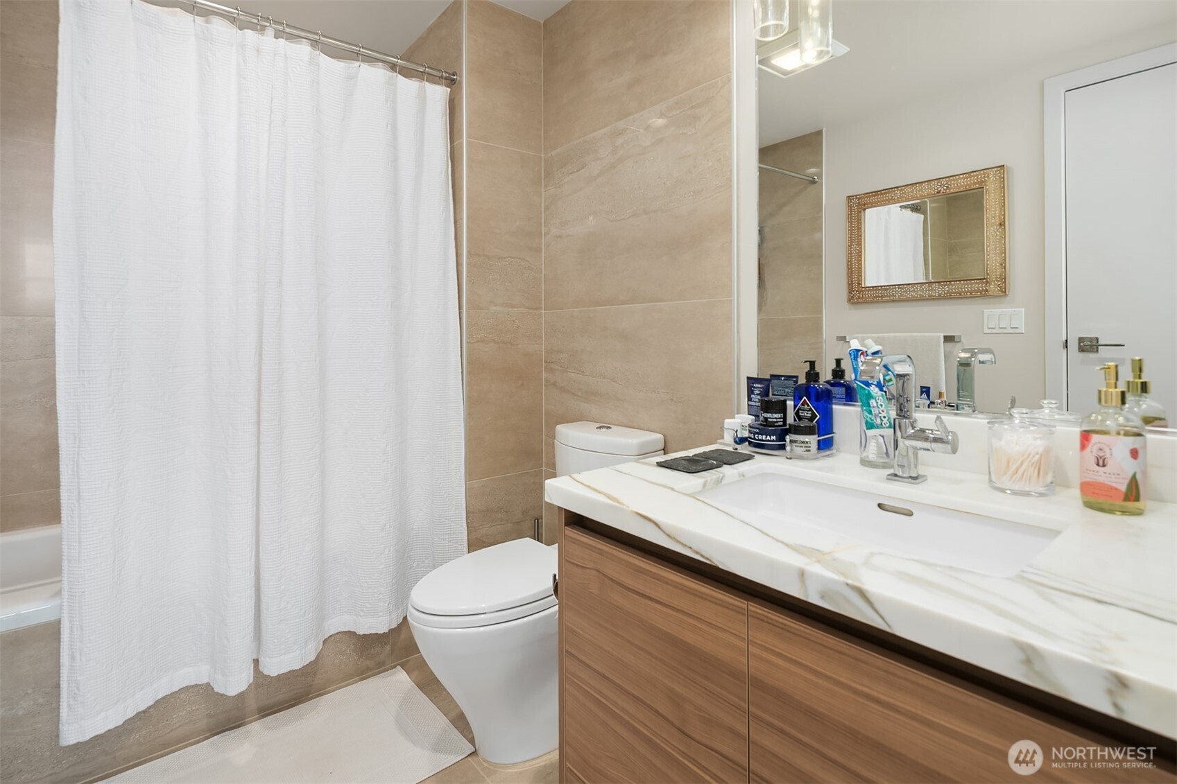 583 Battery Street, Unit 1405N Seattle, WA 98121 - Photo 12 of 37 a bathroom with a sink a toilet and a mirror
